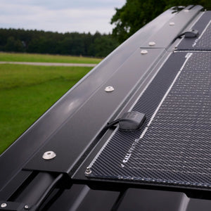 VW T7 camper roof with semi-flexible solar panel module mounted on C-rail.