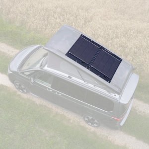 VW T7 Beach camper with monocrystalline solar panel on pop-up roof, parked on a rural path