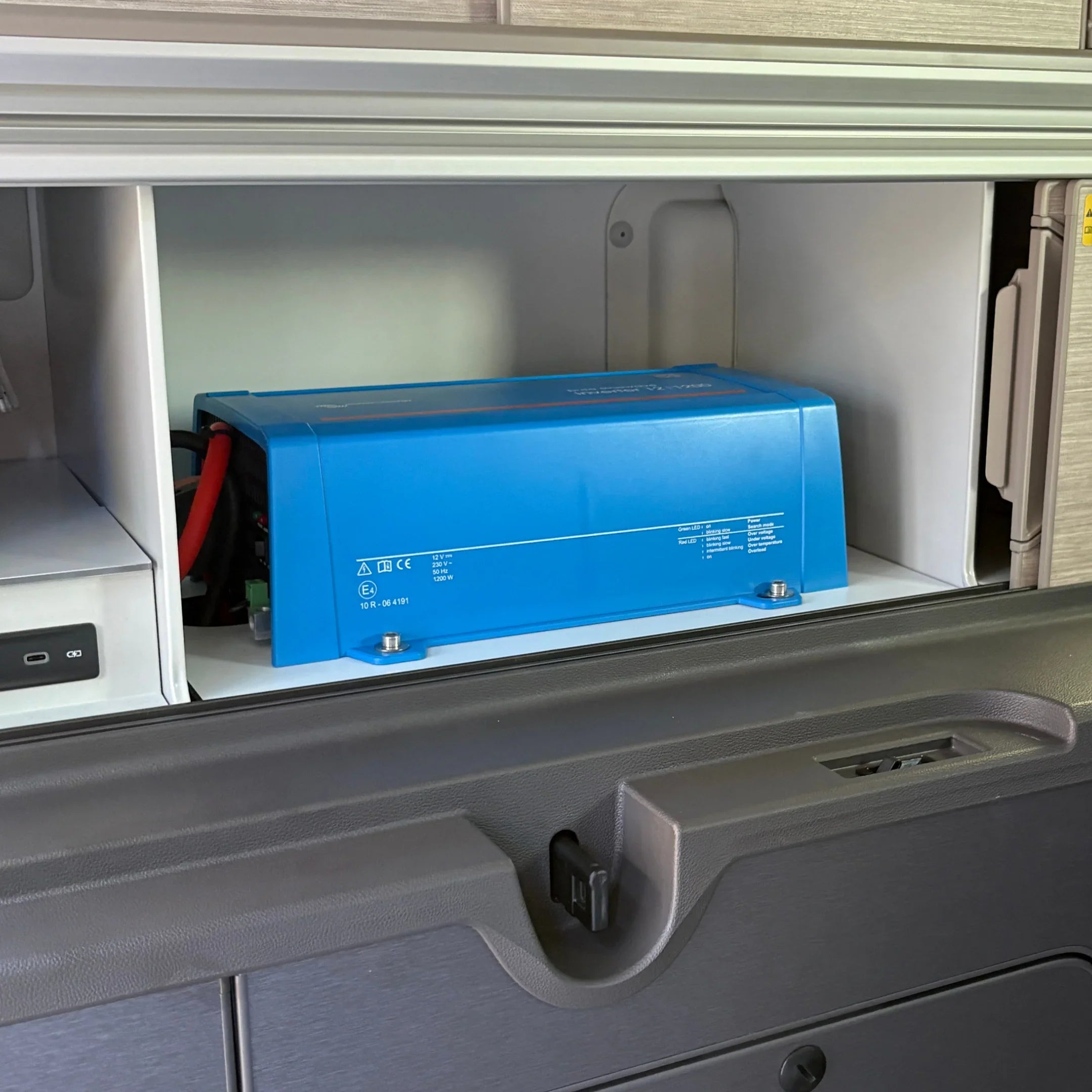 Victron Phoenix 12/1200 inverter installed in VW California camper van cabinet